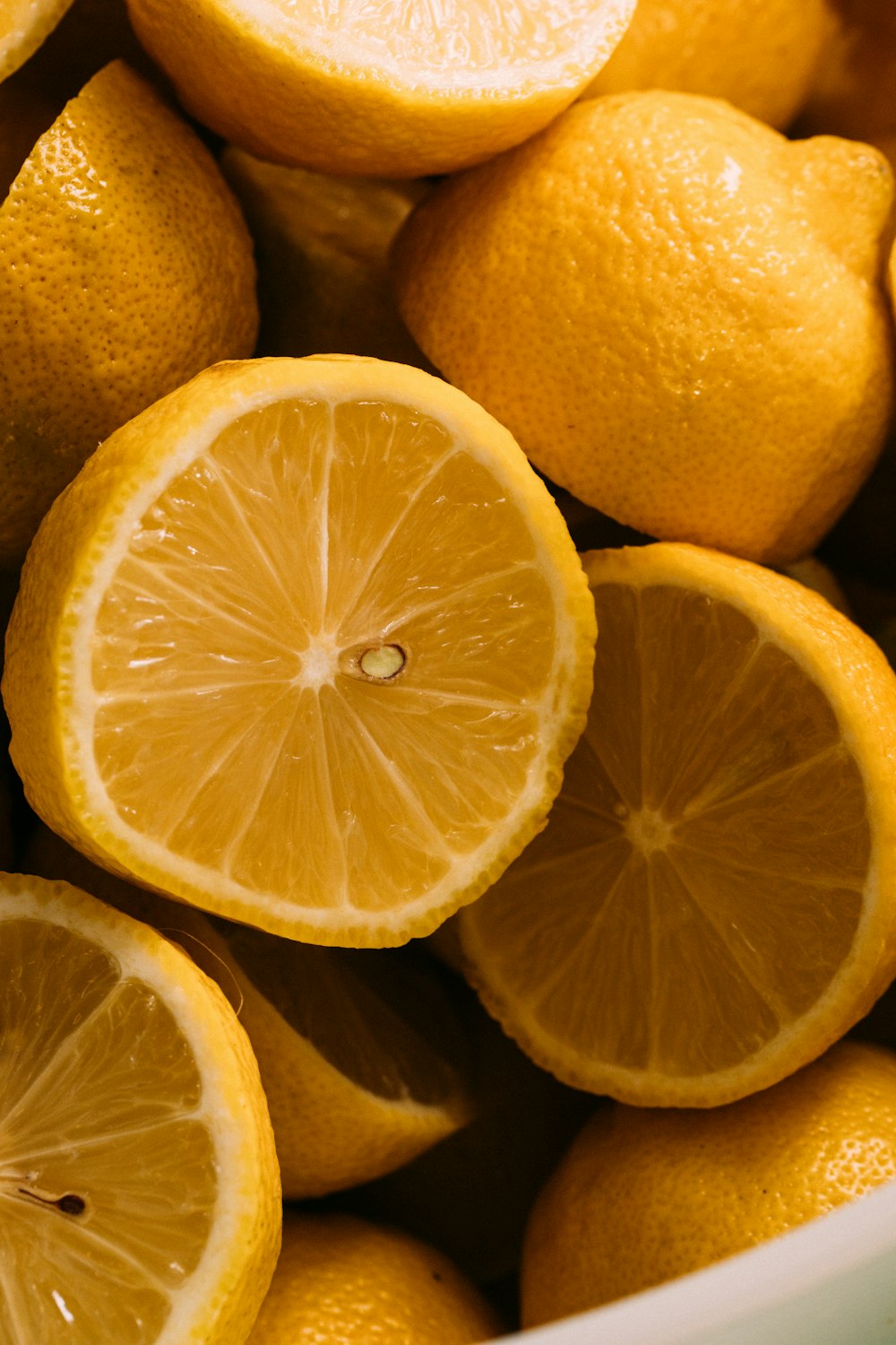 a pile of oranges cut in half