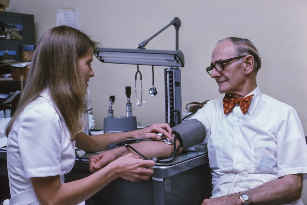 a doctor examining a patient's ankle with a stethoscope