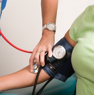 a person with a blood pressure meter on their arm