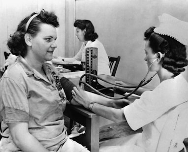 a nurse checking a patient's blood with a stethoscope