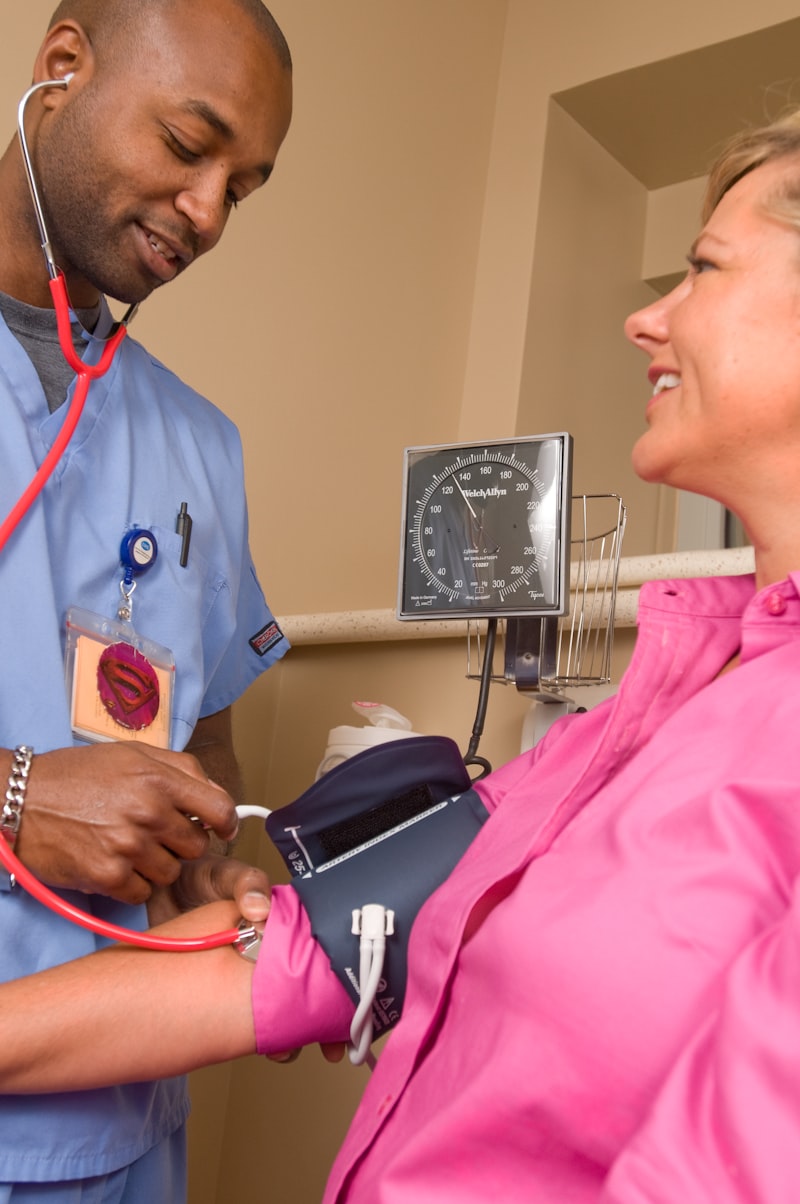 Nurse checking a patient's blood pressure during a visit