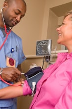 Nurse conducting health assessment with elderly patient