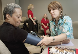 a woman with a stethoscope examines a woman's arm