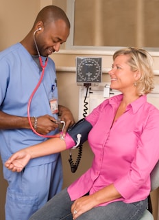 a doctor checking a patient's blood with a stethoscope