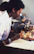 Scientist in a lab coat examining peptide samples with a focused expression.
