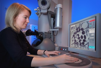 a woman is looking at a computer screen