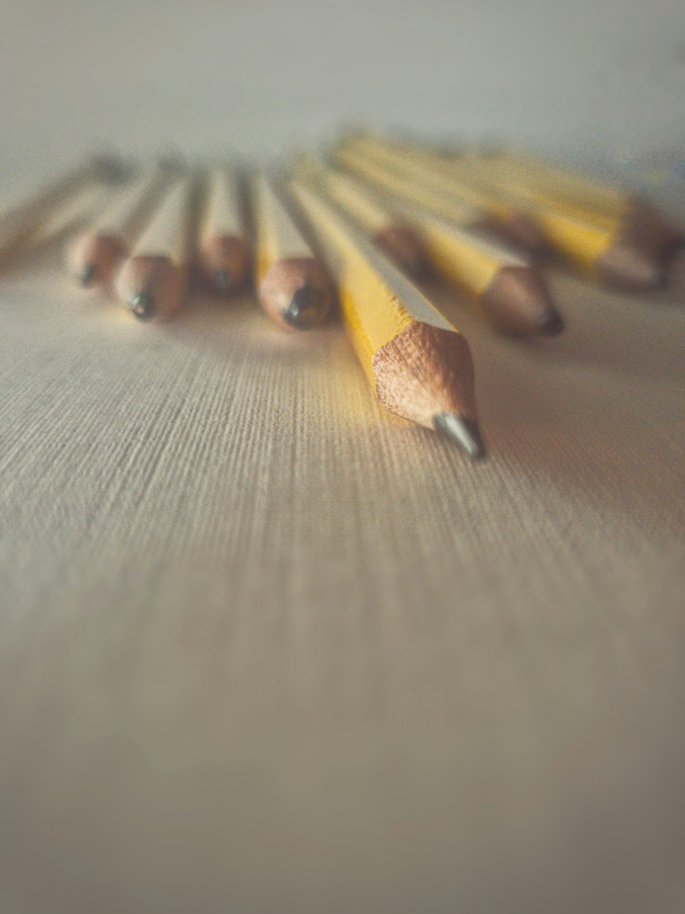 a group of pencils sitting on top of a table