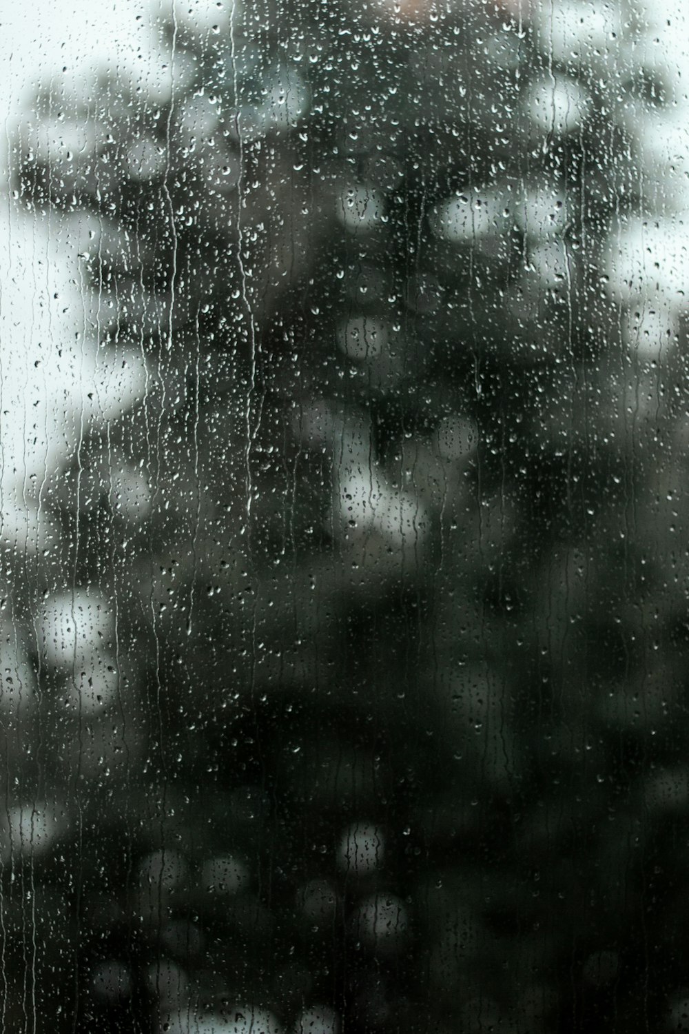 a view of a building through a rainy window