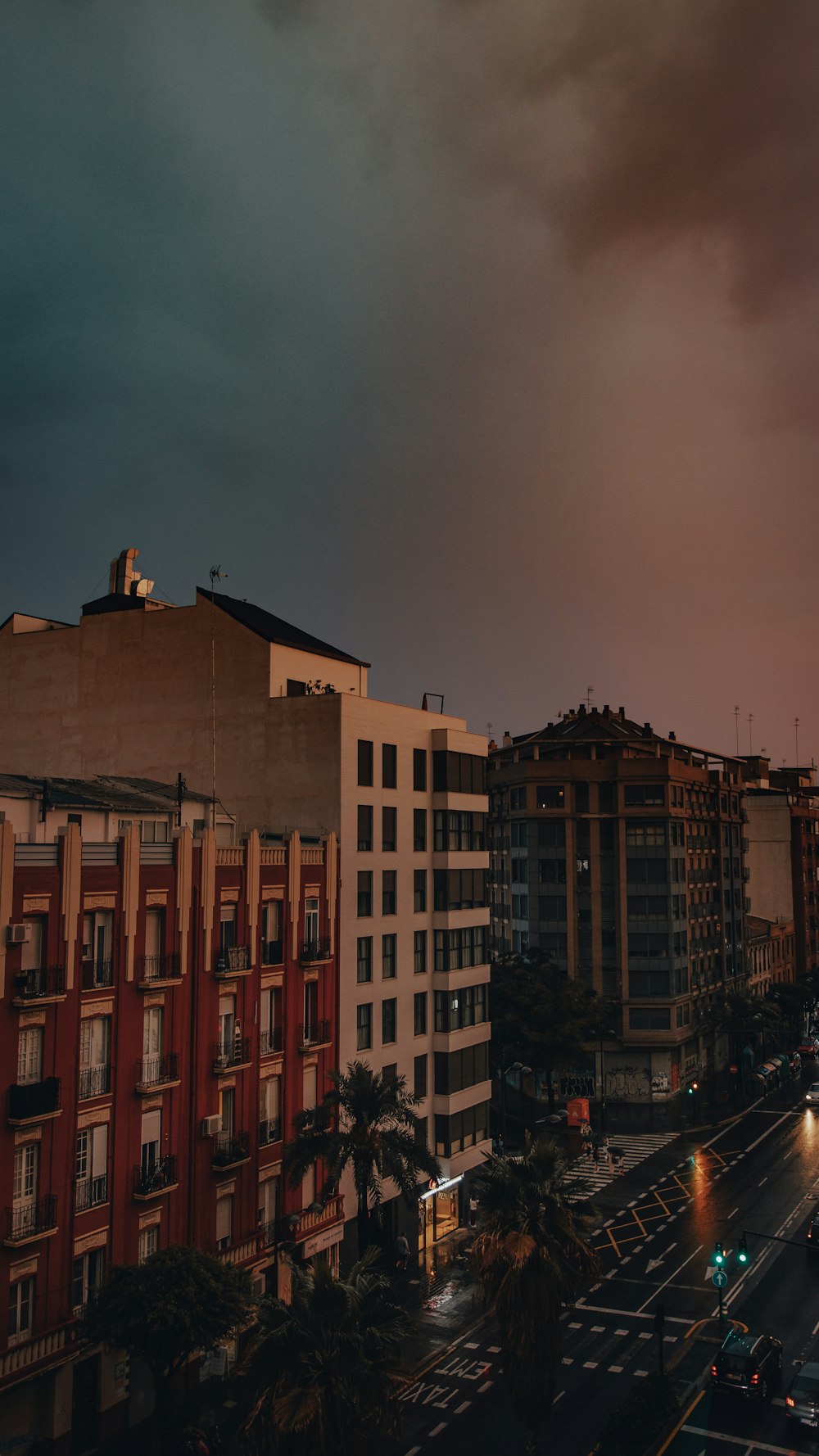  a city street filled with lots of traffic under a cloudy sky