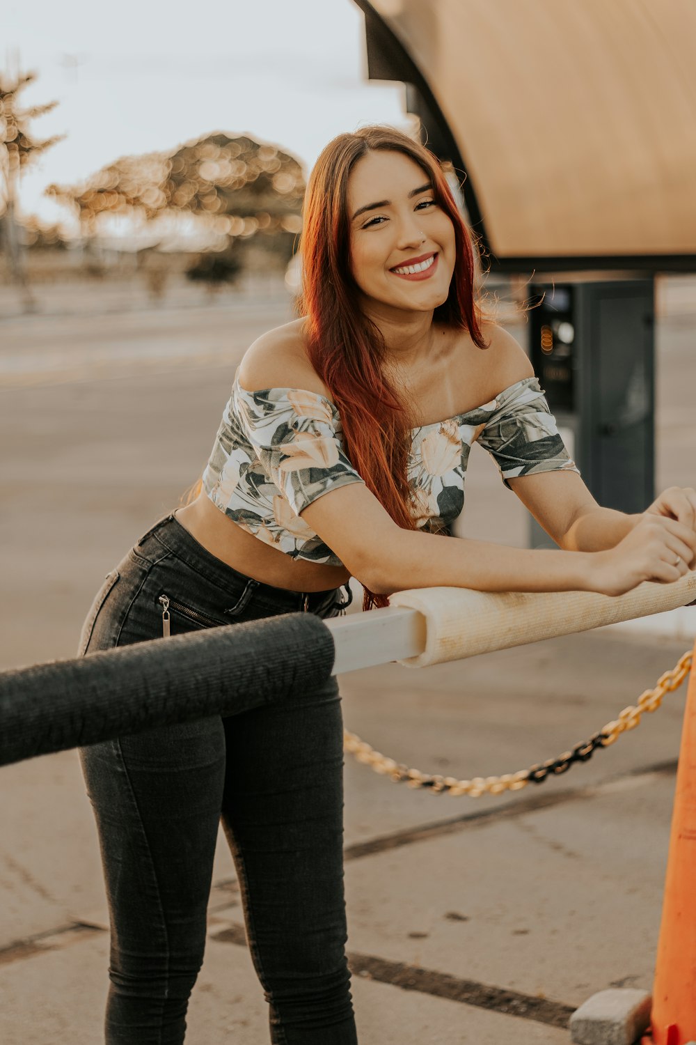 a woman leaning on a rail with a smile on her face