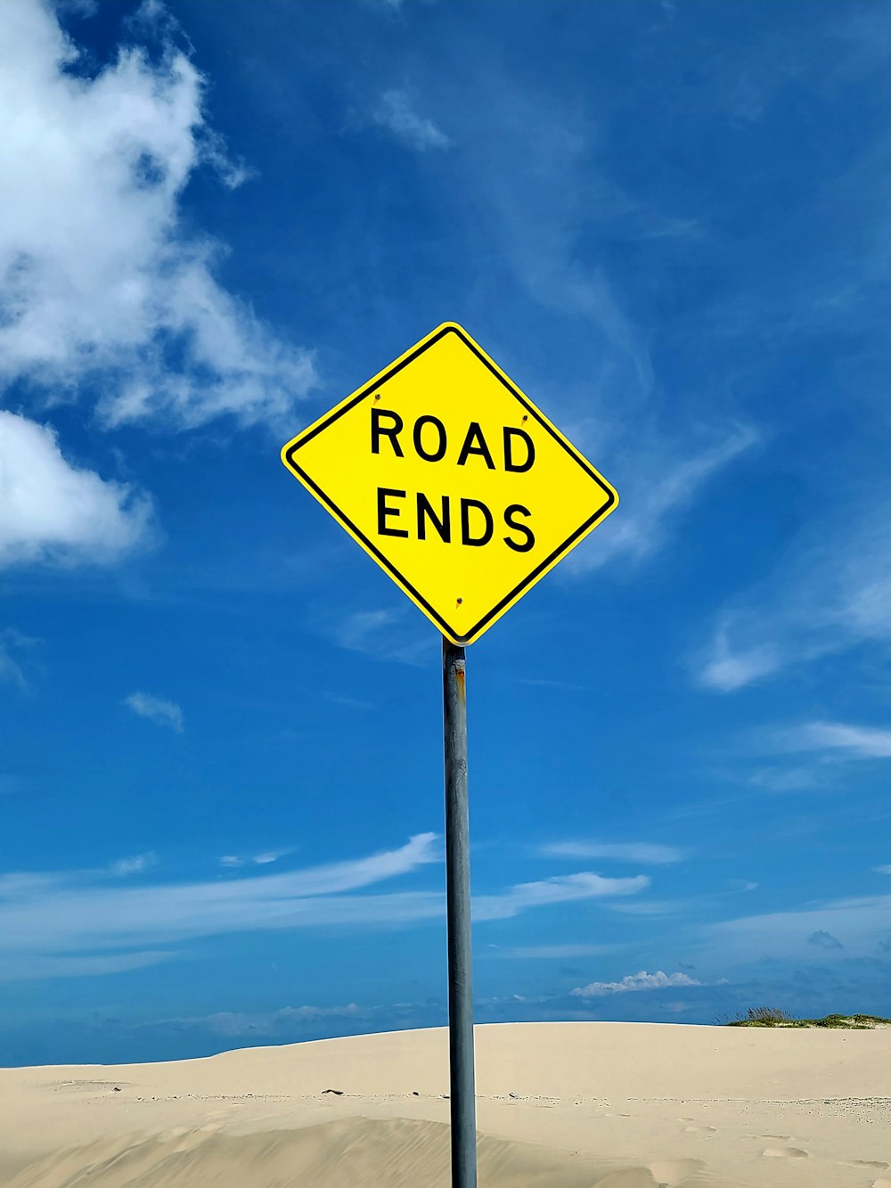 a road ends sign in the middle of a desert