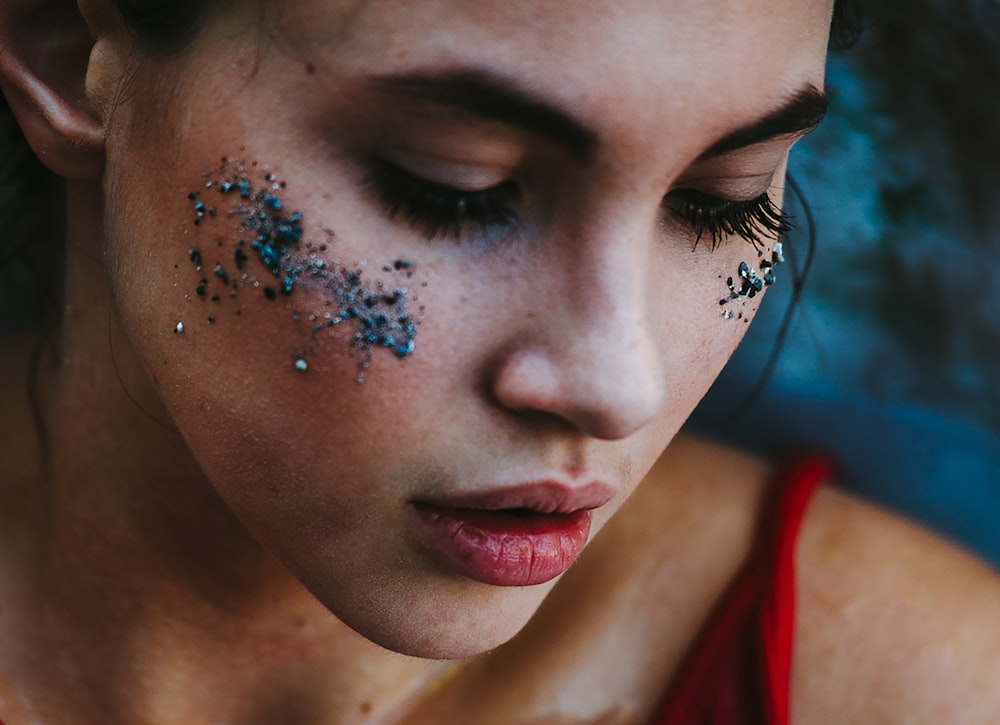 a woman with glitter all over her face