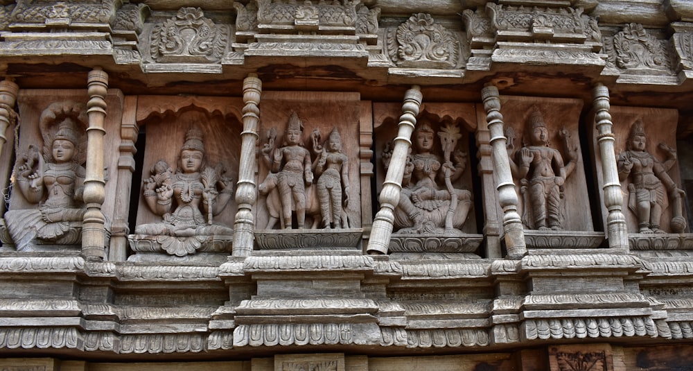 carvings on the side of a building in india