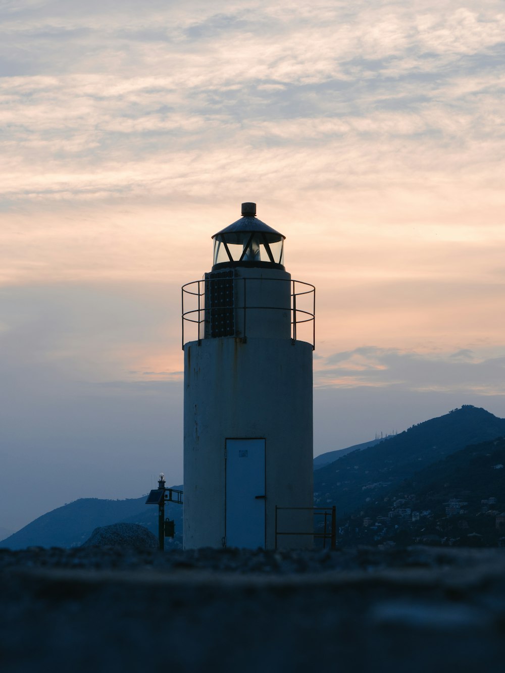 a light house sitting on top of a hill