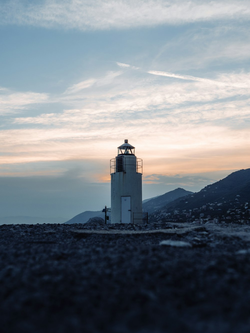 a light house sitting on top of a sandy beach