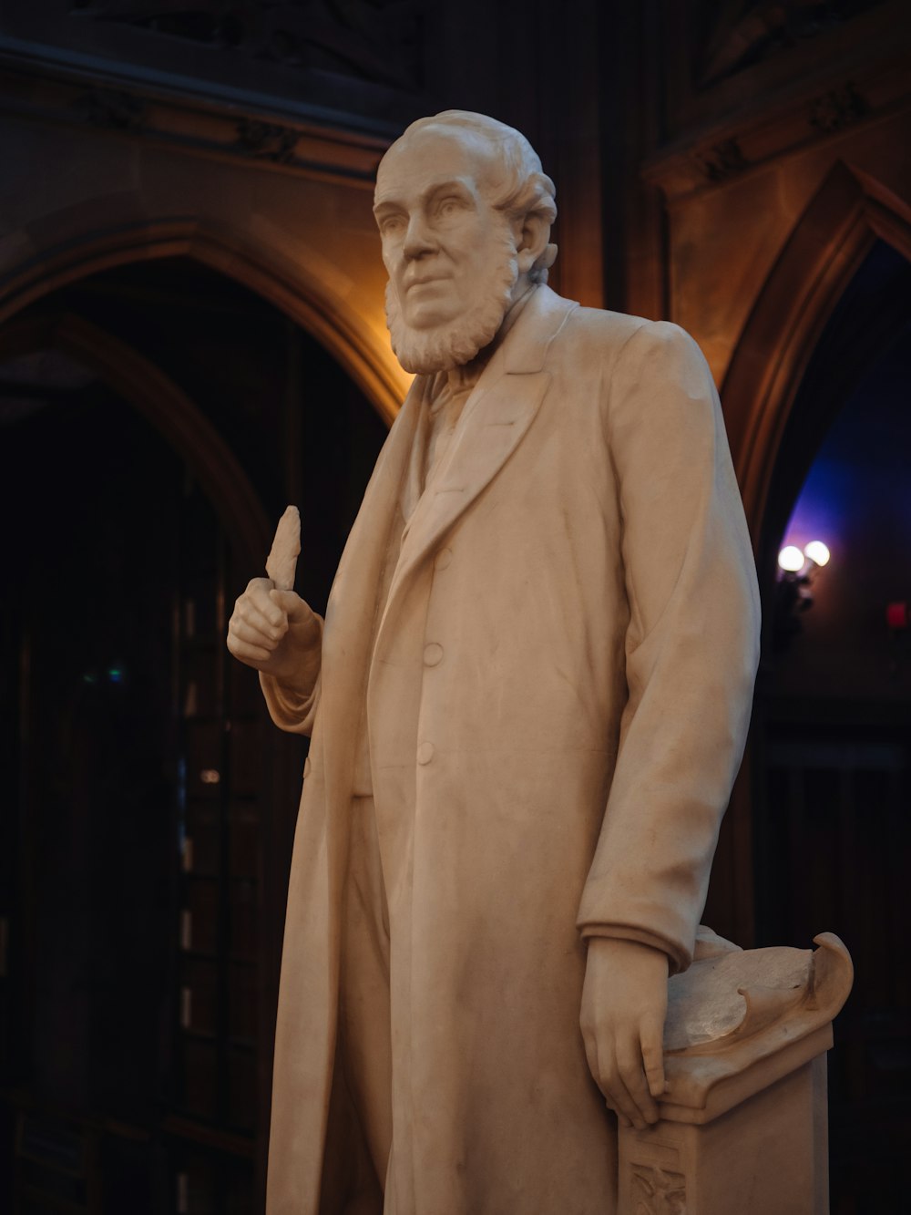 a statue of a man with a coat on