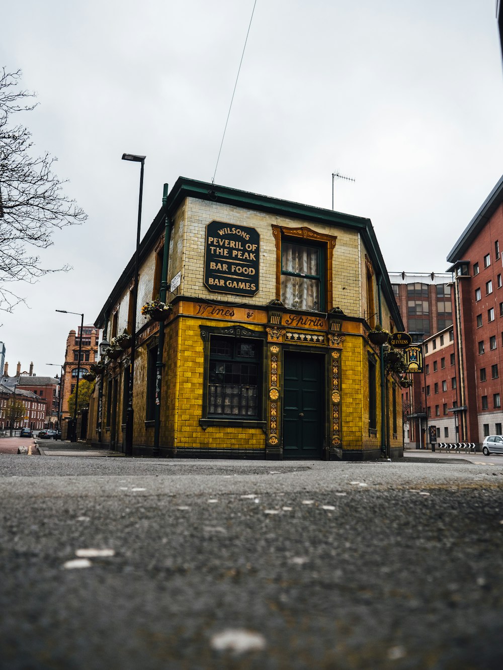 a yellow building with a sign on the front of it