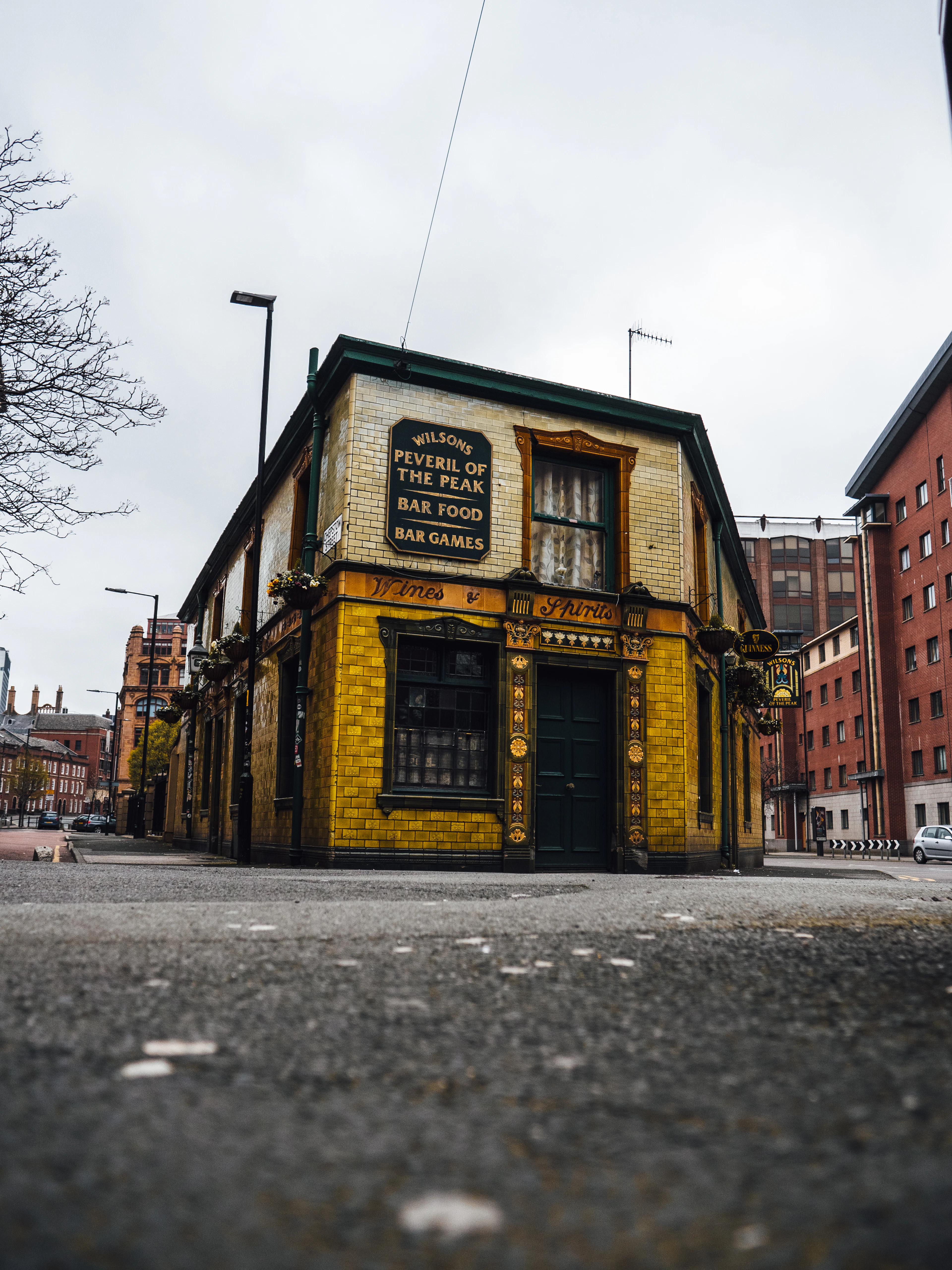 The Peveril of the Peak, a green-tiled Victorian pub standing alone on its corner in Manchester