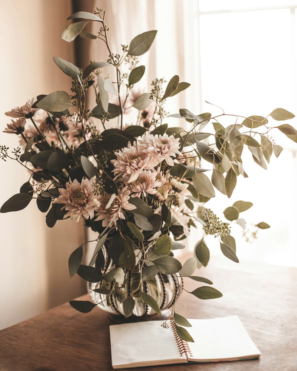 a bouquet of flowers in a vase on a table