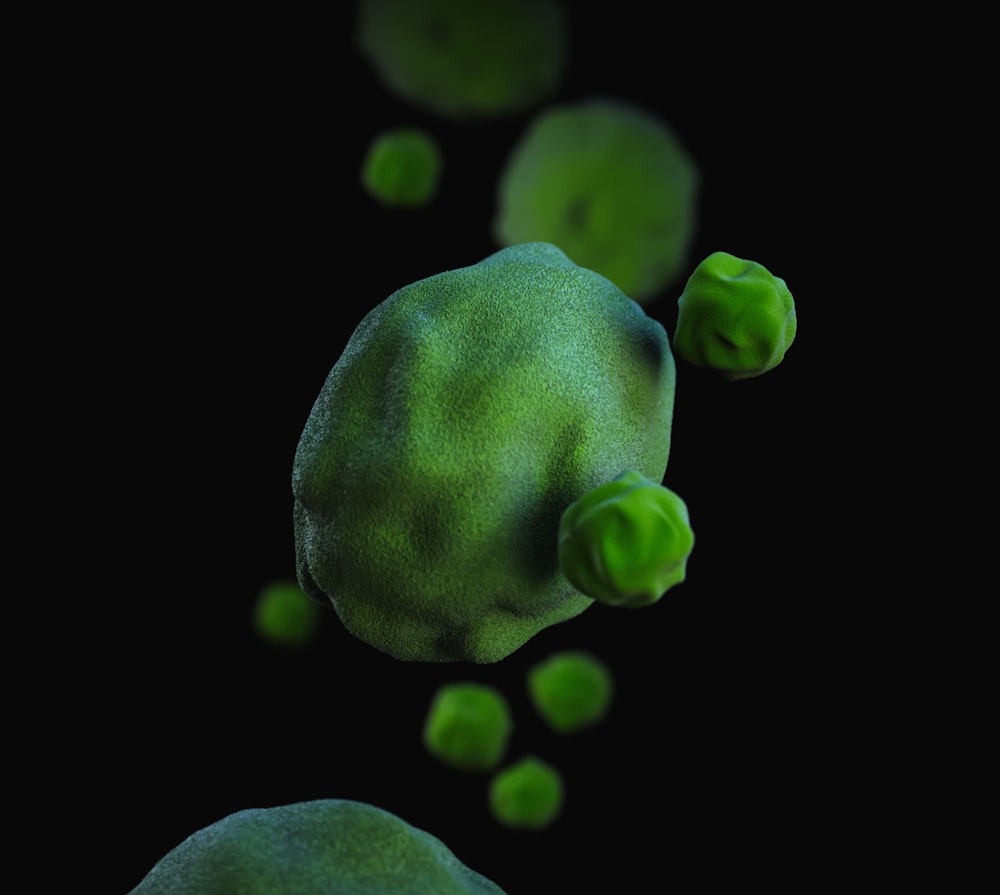 a green substance floating in the air on a black background