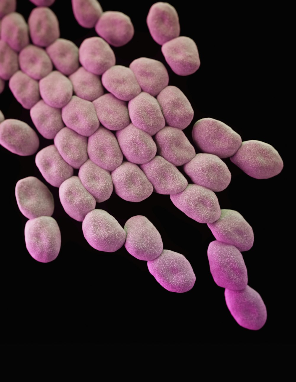 a close up of a pink substance on a black background