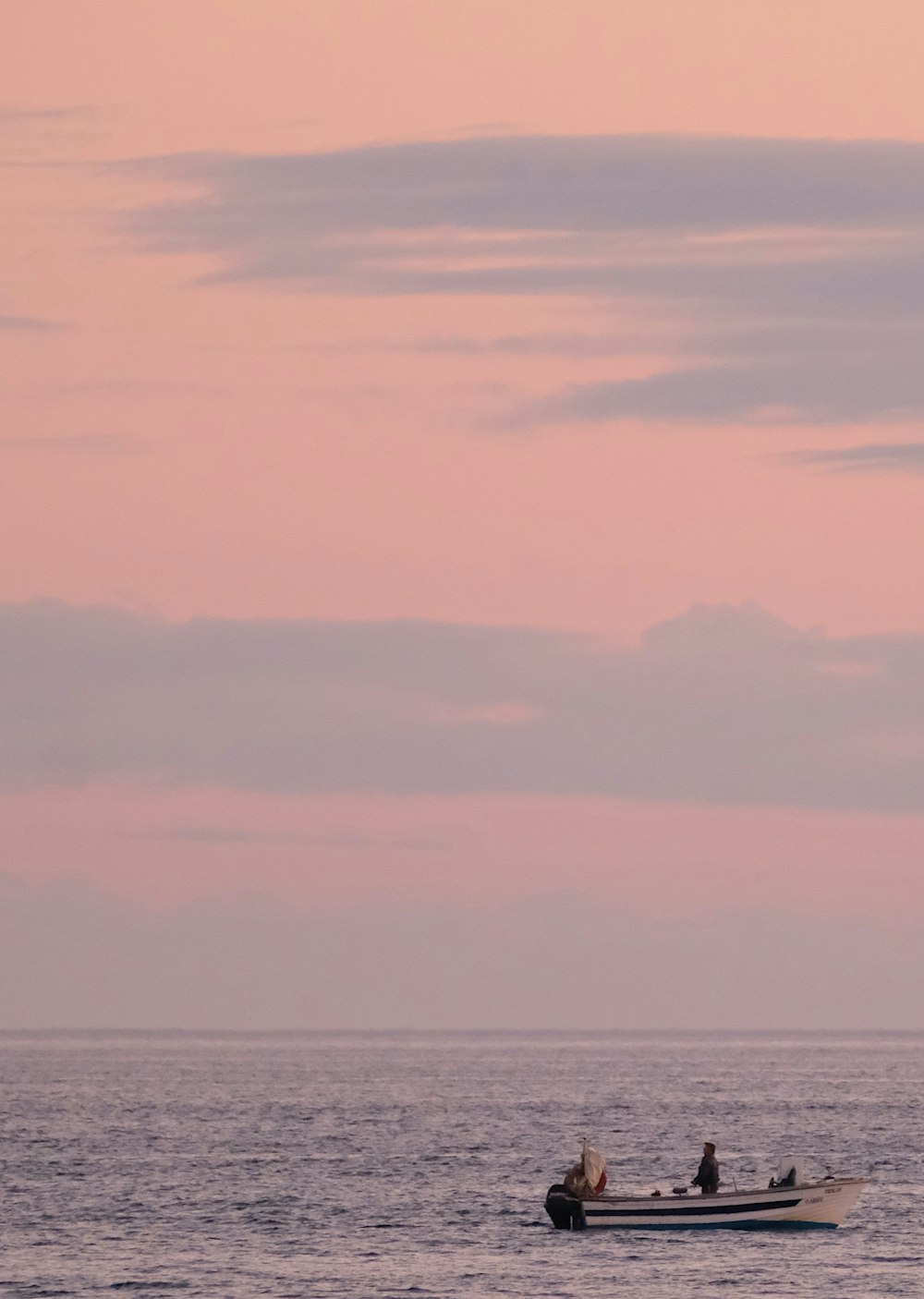 two people in a small boat in the ocean