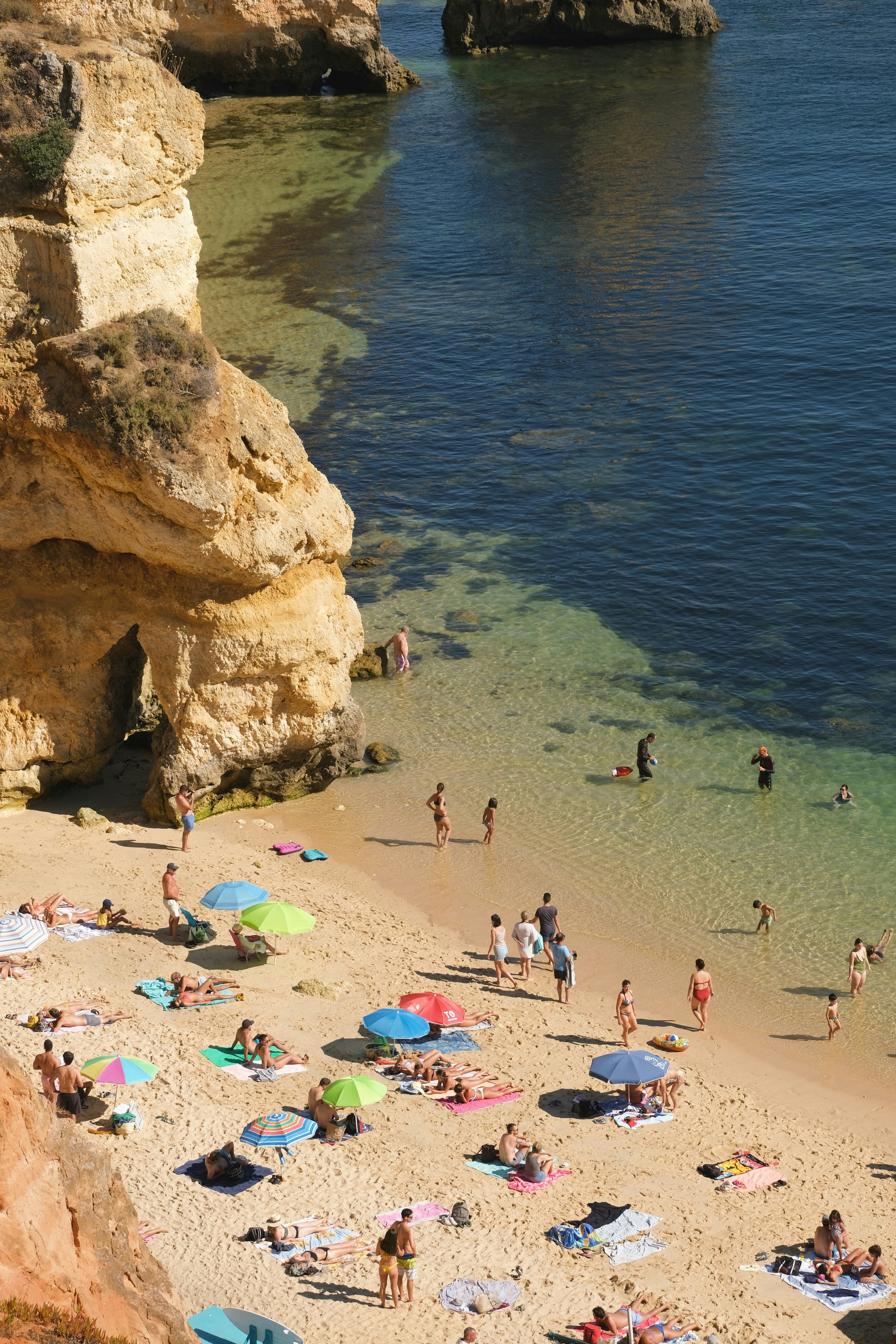 a group of people on a beach near the water