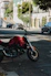 a red motorcycle parked on the side of the road