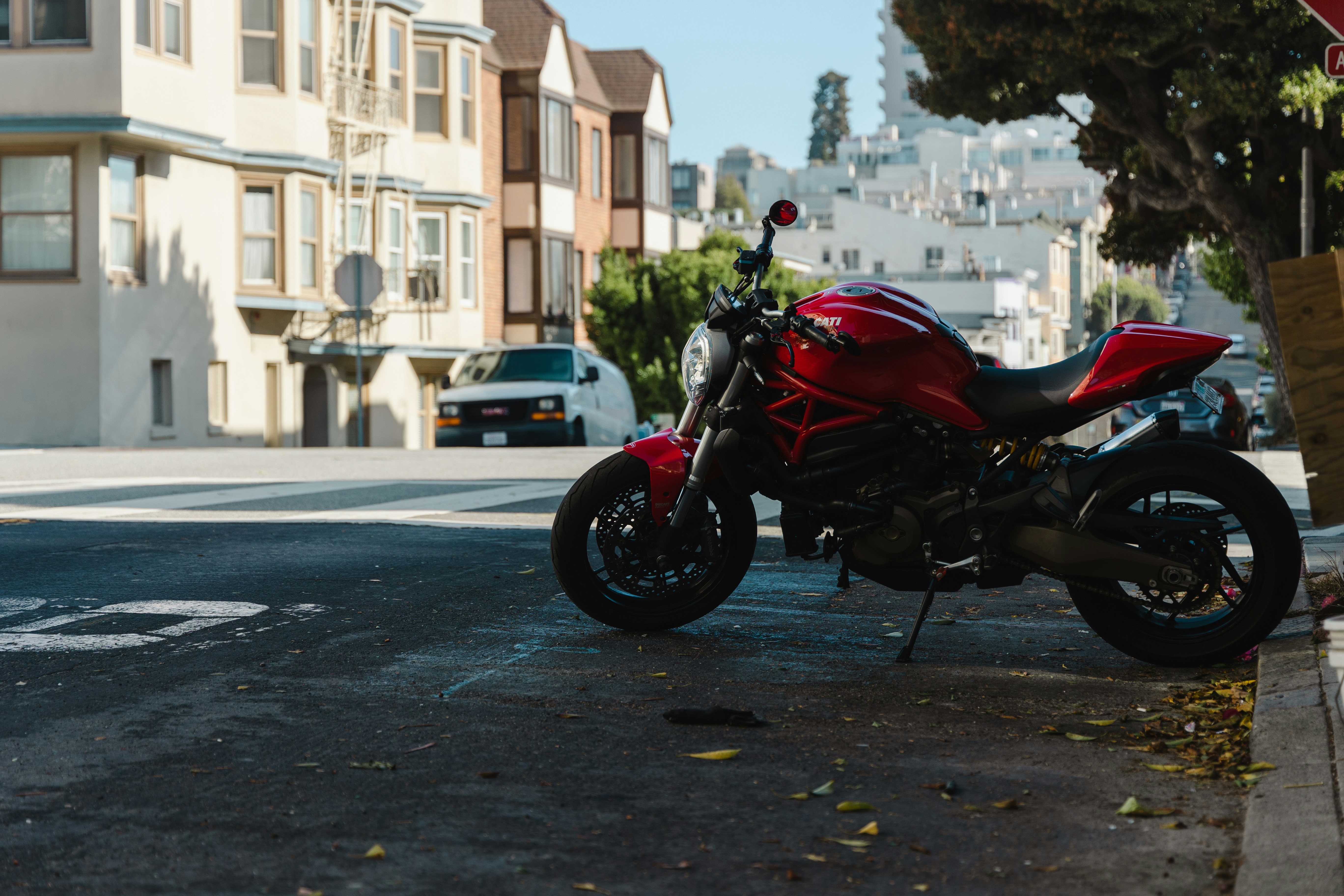 a red motorcycle parked on the side of the road