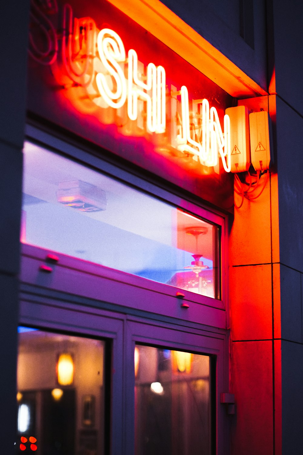 a neon sign is lit up on the side of a building