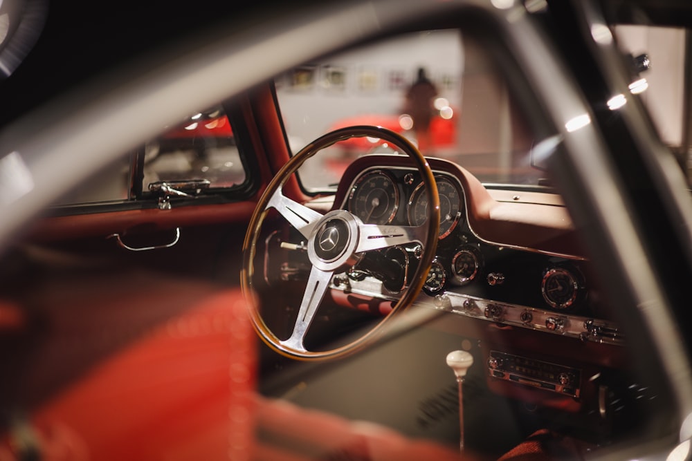 the interior of a car with a steering wheel and dashboard