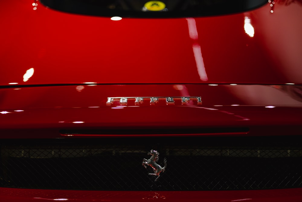 a close up of the hood of a red sports car