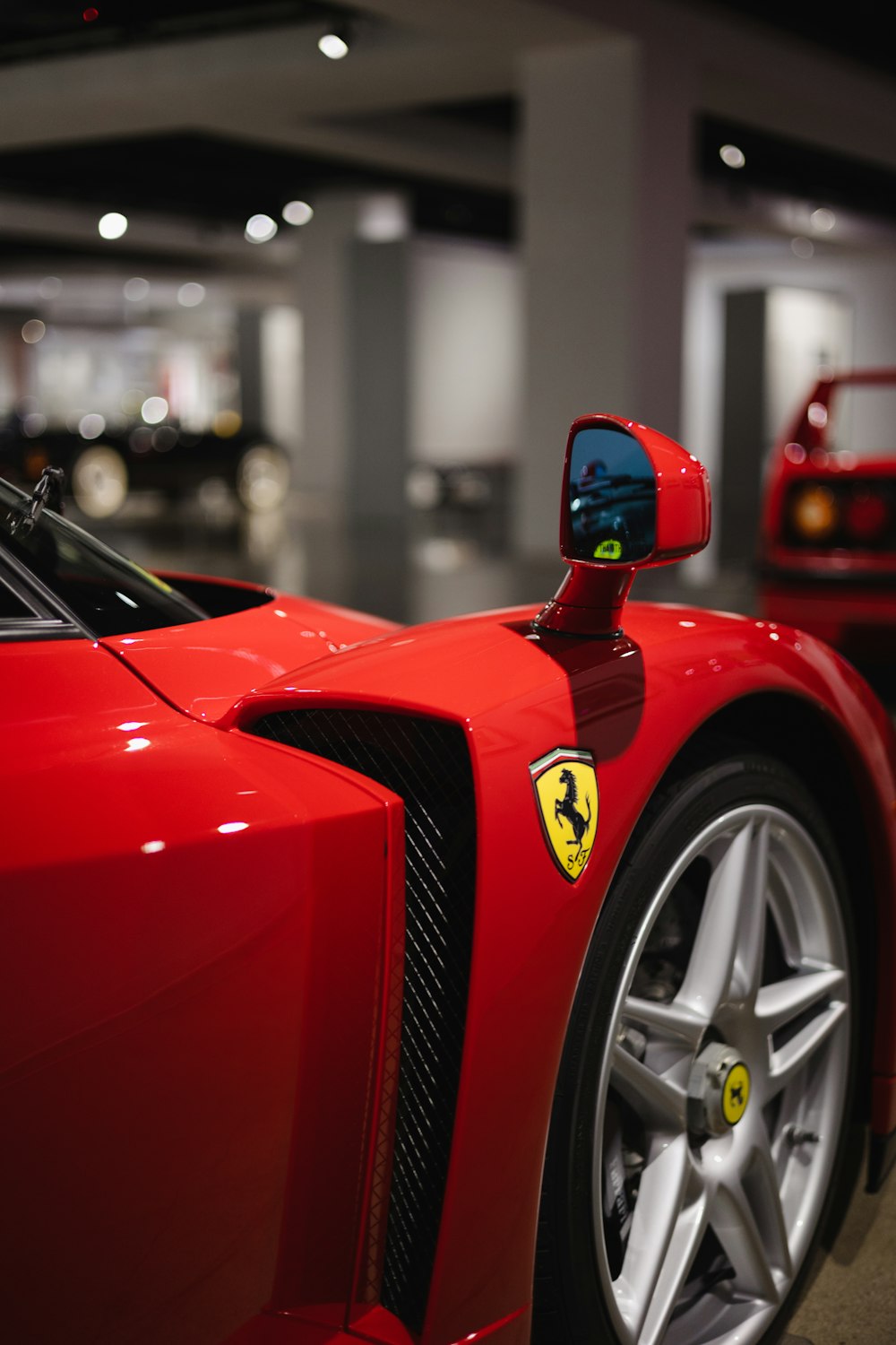 a red sports car parked in a parking garage