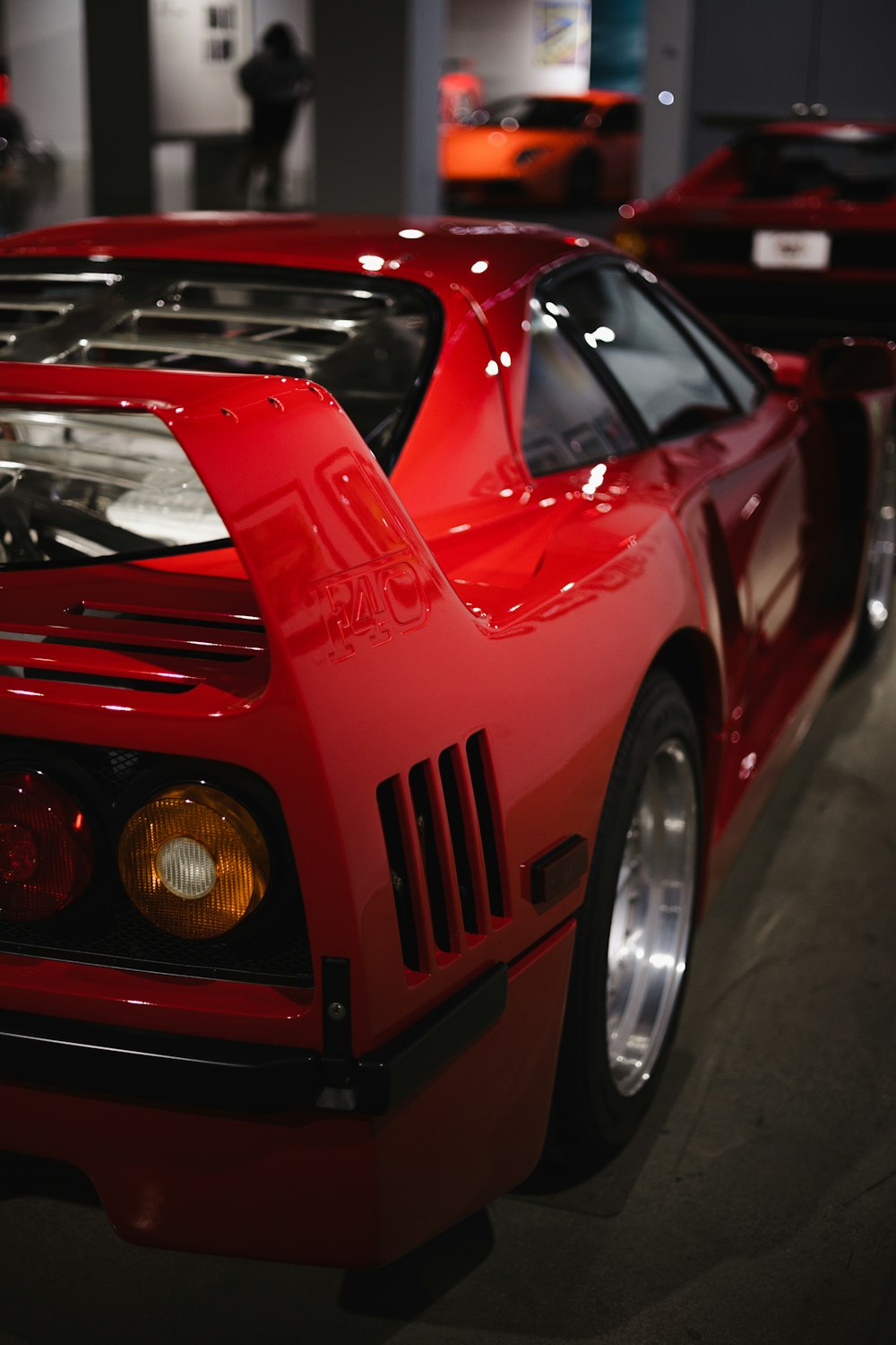 a red sports car on display at a car show