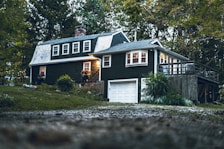 a black house with a white door and windows
