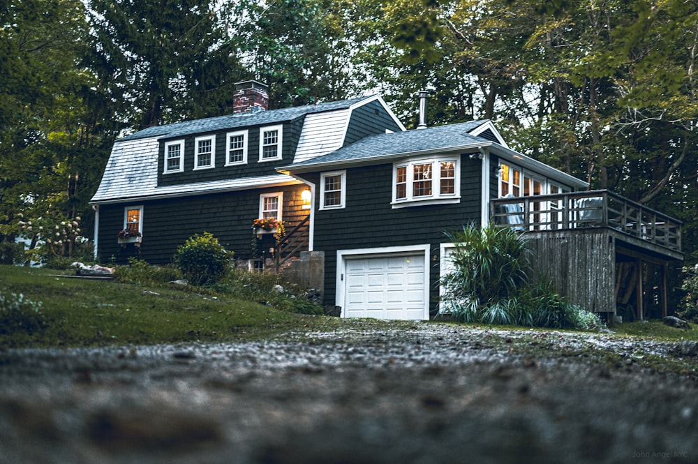 a black house with a white door and windows