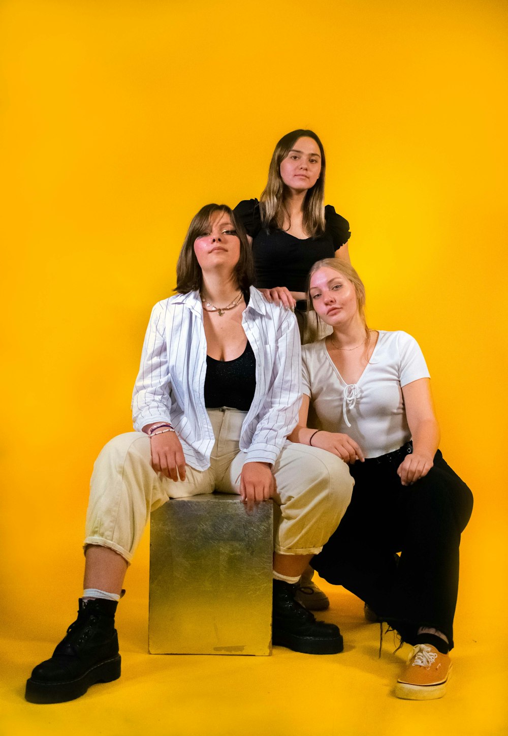 a group of three women sitting next to each other