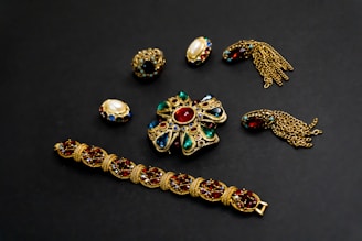 a collection of jewelry on a black surface