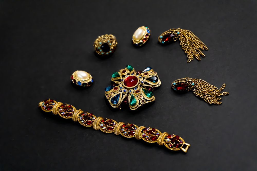 a collection of jewelry on a black surface