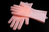 a pair of pink gloves sitting on top of each other