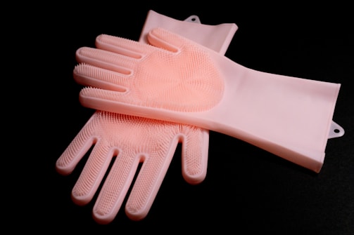 a pair of pink gloves sitting on top of each other