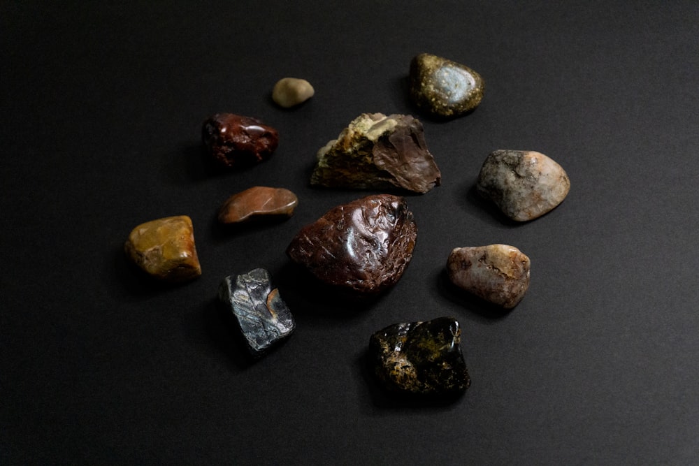 a group of rocks sitting on top of a black surface