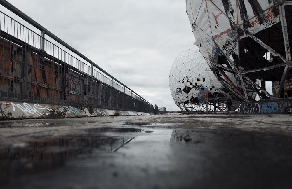 a large metal object sitting on top of a cement ground