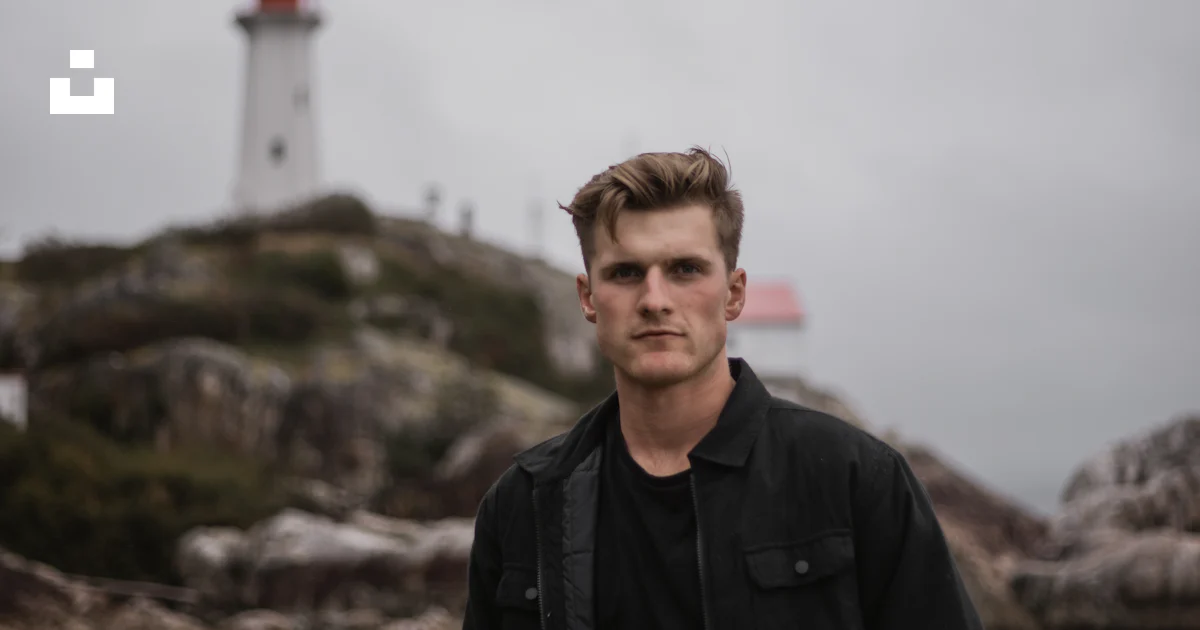 A man standing in front of a lighthouse photo – Free Human Image on ...