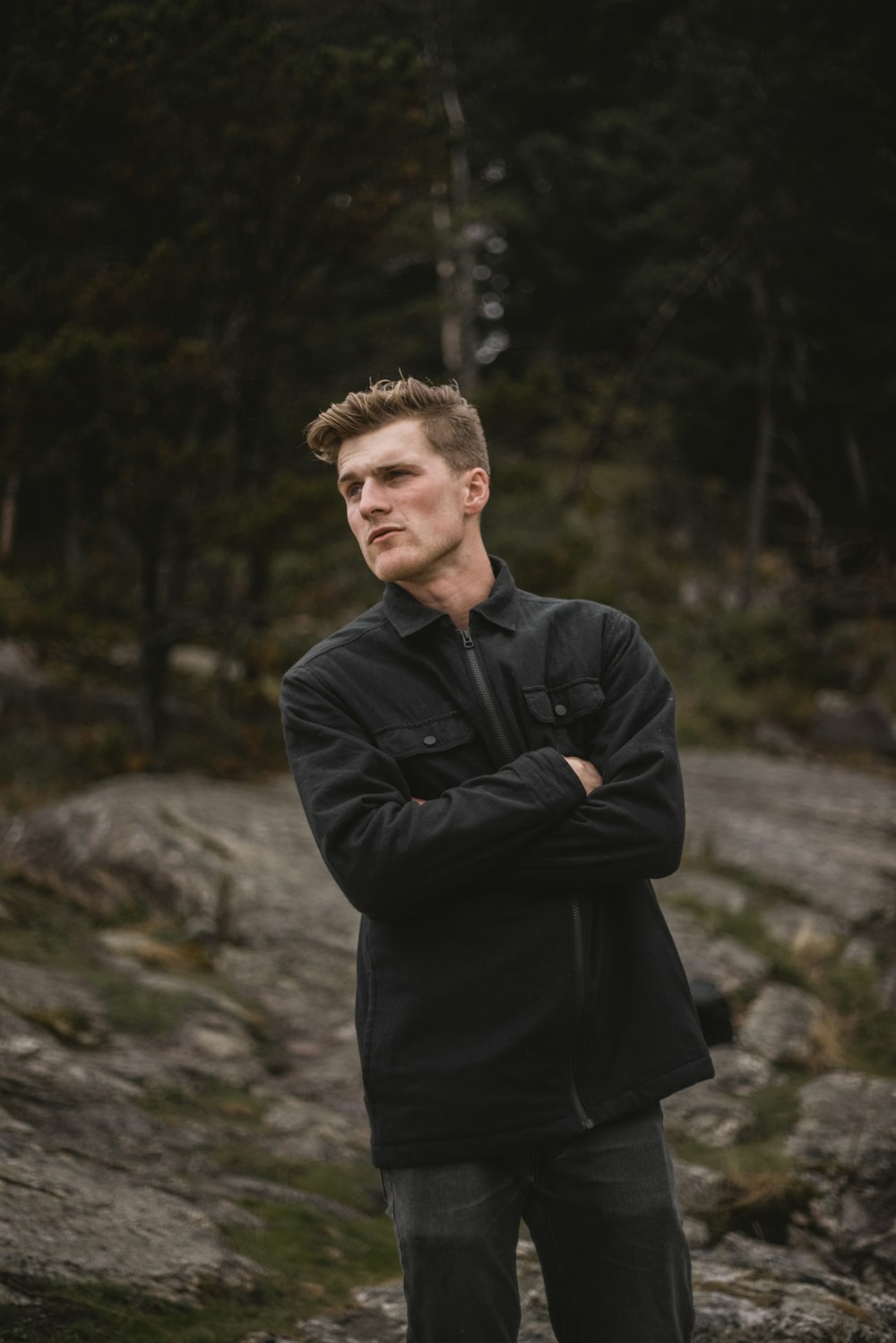 a man standing in front of some rocks