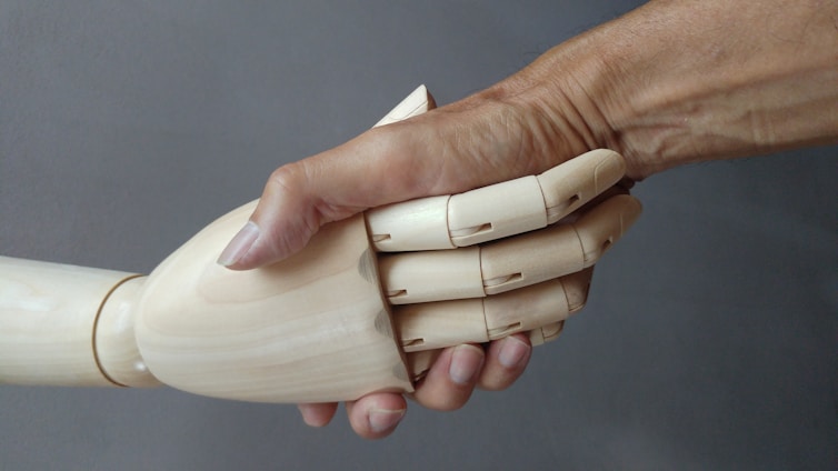 a close up of a person holding a wooden object