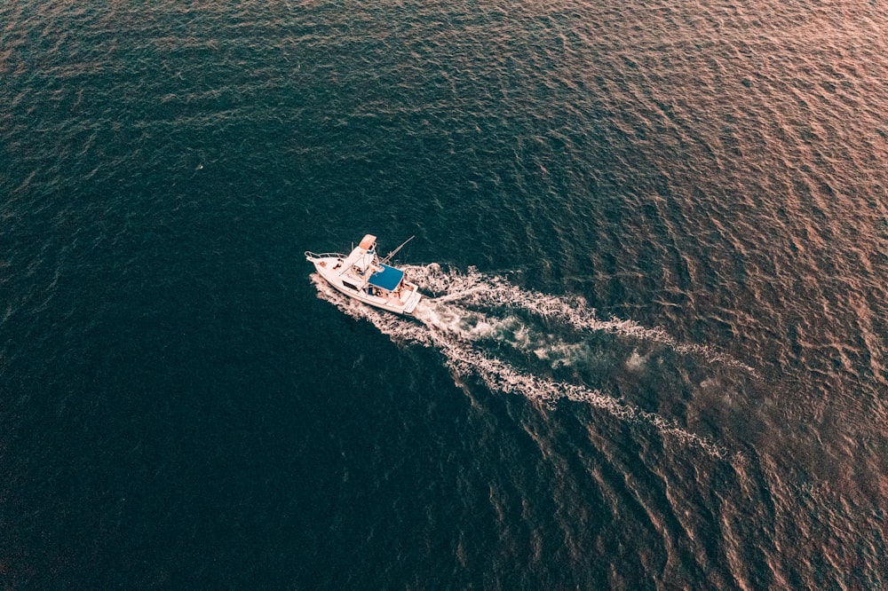 a small boat in the middle of a body of water