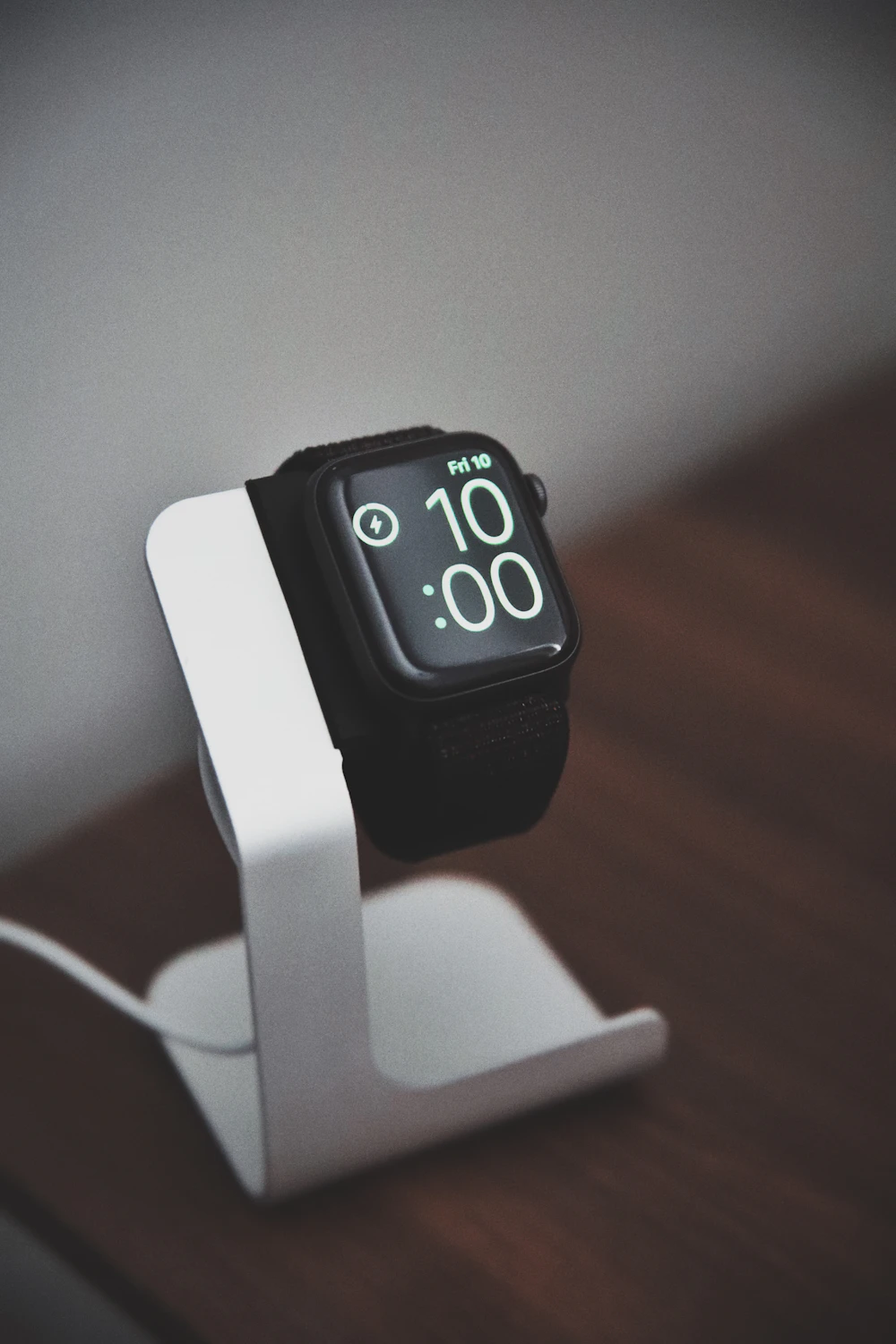 Smartwatch charging on a white stand