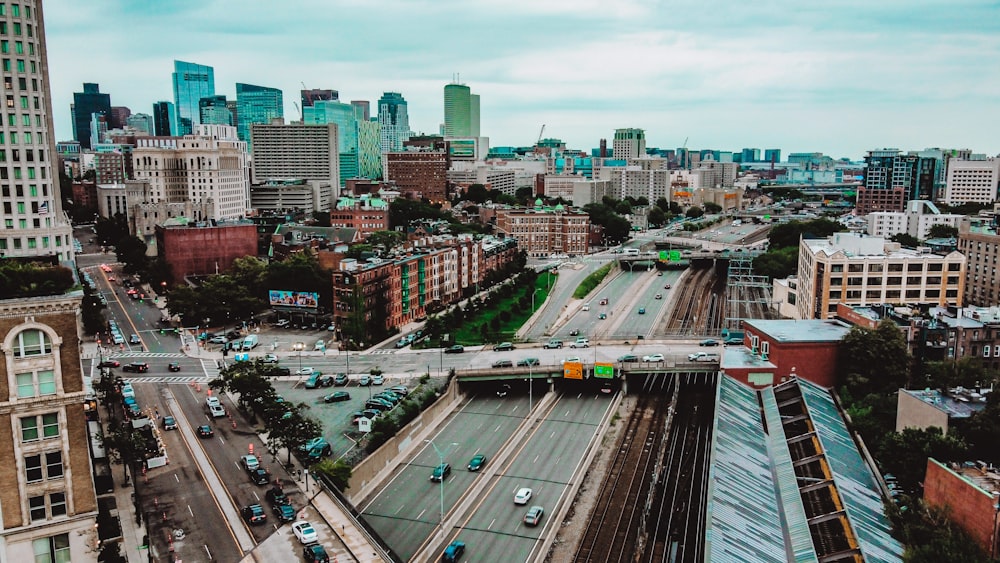 an aerial view of a city with a train on the tracks