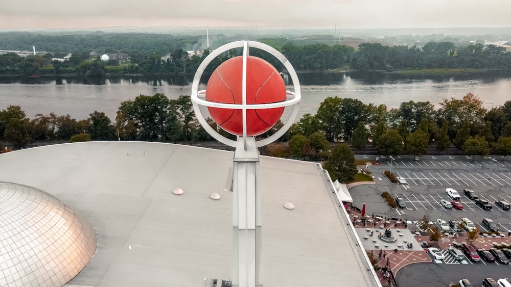 a large red ball on top of a building